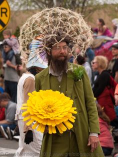 a man with a large flower in his hair