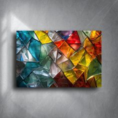 an abstract painting with many different colors on the wall and in front of it is a grey background