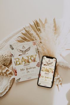 the baby in bloom birth announcement is next to an open cell phone on a table