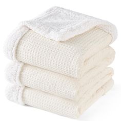 four white towels stacked on top of each other