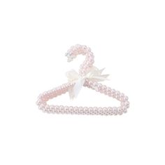 a pink pearl and white bow tie on top of a headband with pearls in the middle