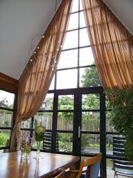 a dining room table with chairs and a large window