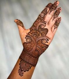 a hand that has some henna on it