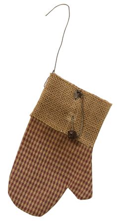 a brown and white checkered oven mitt hanging from a string