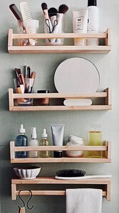 three wooden shelves filled with cosmetics and personal care items