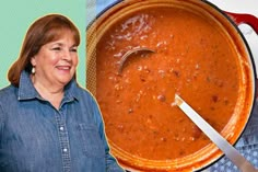 a woman standing in front of a pot of soup