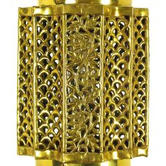 a gold cuff with intricate designs on it