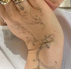 a close up of a person with tattoos on their hands