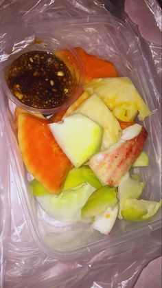 a plastic container filled with different types of fruit