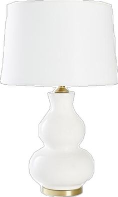 a white lamp with a gold base and a white shade on the top, against a white background