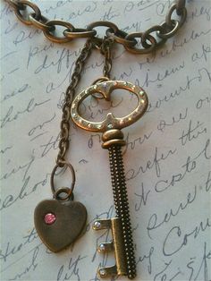 Handmade Vintage Key Heart Necklace, Victorian, Steampunk, Romantic This listing is for a Handmade, Vintage, Romantic Inspired Womens Necklace.  I call this one Key to my Heart. It has an antique gold chain with two charms hanging from it.  One is an antique key with Rhinestones and the other is a heart with a pink rhinestone embedded into the metal.  This vintage replica is sure to add elegance and style to any attire.  Thanks for viewing! All Materials are nickel free.  I myself have highly se Vintage Gold Jewelry With Keys, Gold Brass Necklace With Keys, Antique Gold Necklaces With Two Keys, Gold Heart Necklace With Two Keys, Vintage Key Necklaces As Gift, Vintage Gold Necklaces With Keys, Vintage Key Necklace Jewelry, Vintage Metal Jewelry With Two Keys, Vintage Metal Jewelry With Keys