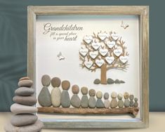 a family tree made out of rocks sitting on top of a table next to a pile of stones