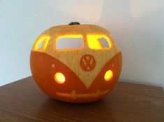 a pumpkin carved to look like a vw bus is sitting on top of a table