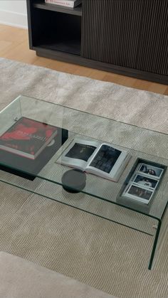 a glass coffee table with books on it