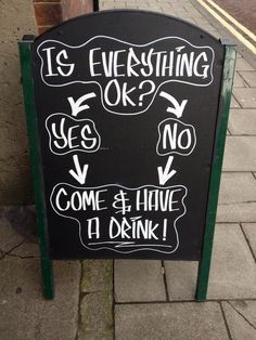 a sign on the sidewalk that says it's everything ok and no come & have a drink