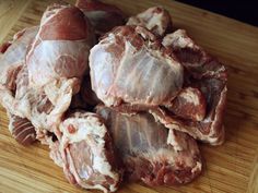 some raw meat on a wooden cutting board