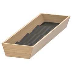 an empty wooden box filled with lots of black paper in it's bottom compartment