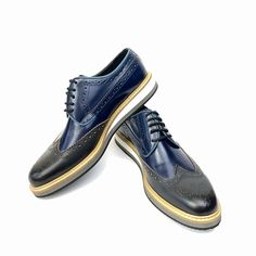 Scarpetto Navy Blue Wingtip Dress Shoes for men are presented in genuine leather. Its lace-up designs characterize the latest collections. With a wingtip and stchiting design, this dress shoe is defined by its unique style and quality. The shoe's refined material and lace-up detail mix with elements taken from the world to create a versatile piece that blends a casual look. Built with genuine leather offers a classy finish and superior stability. A polished genuine leather upper delivers a distinctive everyday look. You can buy this plain shoe for your individual style. You can pair them down to complete a smart formal look. Product Features  Genuine Leather, Fitted with EVA Sole Upper Material: Calf Leather Inner Material: Sheep Leather Sole Material: EVA Shoe Width: Medium(B,M) Heel Heig Designer Wingtip Brogue Lace-up Shoes, Designer Lace-up Wingtip Brogue Shoes, Designer Wingtip Lace-up Shoes For Derby, Designer Wingtip Dress Shoes With Brogue Detailing, Designer Lace-up Oxfords With Brogue Detailing, Elegant Blue Lace-up Oxfords, Navy Oxfords With Brogue Detailing For Business, Navy Wingtip Leather Shoes For Business, Designer Wingtip Dress Shoes For Derby