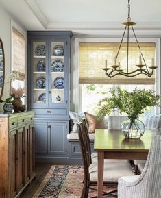 a dinning room table with chairs and plates on it