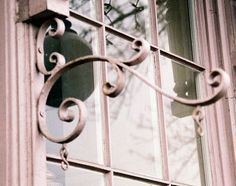 an old window with iron work on it