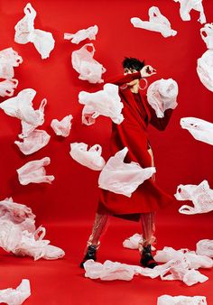 a woman in a red dress surrounded by white tissue