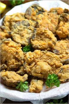 a white plate topped with fried chicken and parsley