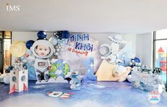 an astronaut themed birthday party with balloons and decorations on the wall, including paper cutouts