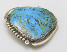 - Gorgeous Large Zuni Natural Turquoise & Sterling Silver Brooch- Brooch signed on back "BE Zuni"- Natural turquoise stone has lots of personality and measures 42.5mm tall by 38mm wide- Stone is surrounded by wonderful sterling work including drop and star stamp details  - Brooch measures 1.93" tall by 1.9" wide and .29" deep- Brooch weighs 20.3 grams- Very good vintage condition with patina to sterling (estate piece, we have not cleaned) Handmade Turquoise Brooches For Collectible, Unique Handmade Turquoise Brooch, Unique Handmade Turquoise Brooches, Natural Turquoise Stone, Sterling Silver Brooch, Silver Brooch, Natural Turquoise, Turquoise Jewelry, Turquoise Stone