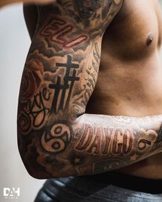 a man with many tattoos on his arm