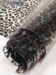 an animal print wallpaper with black and white leopard spots on the back, as well as a cheetah pattern