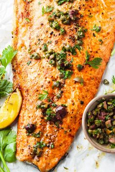 a close up of a piece of fish with garnishes