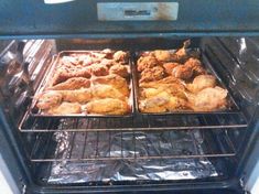 two trays of food cooking in an oven