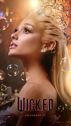 a woman with blonde hair wearing a tiara in front of bubbles