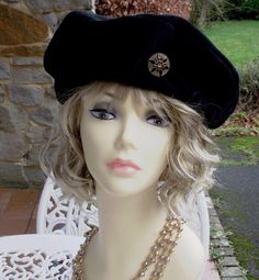 This is a traditional beret in black velvet, adorned with a gorgeous Czech glass button of black geometric flower design on gold.  Lined in black satin and finished with a gorgeous navy grosgrain ribbon.   This is truly a gorgeous hat!   The size of the hat DESIGN is a medium size: not too cropped to the head, but not oversized either.   You MUST tell me your head size measurement, inches is fine, around your head over the ears, as these are sized and made couture style insofar as fit is concern Elegant Adjustable Black Beret, Elegant Black Beret For Party, Elegant Adjustable Winter Beret, Elegant Fitted Beret For Parties, Elegant Adjustable Beret For Parties, Couture Style, Satin Noir, Hat Design, Geometric Flower