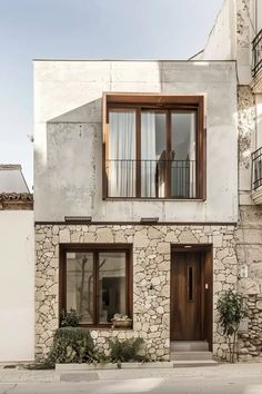 an old stone house with wooden doors and windows