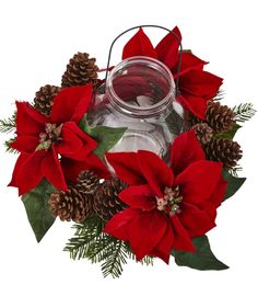 a glass jar filled with poinsettia and pine cones