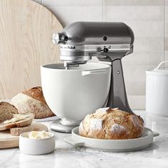 a mixer and some bread on a counter