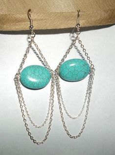 "Great for parties, weddings, career, everyday.   Turquoise is the stone that represent love. These earrings are handcrafted with large  oval turquoise beads and 2 loops of silver plated chains at the bottom  that are different in size.attached to loops at the end of each end of the oval turquoise stone. These earrings hang just under 3.5\" long from the earwire. Free Shipping to US buyer!" Chain Chandelier, Turquoise Chandelier, Silver Chain Earrings, Silver Chains, Beaded Anklets, Feather Earrings, Natural Turquoise, Chain Earrings, Blue Earrings