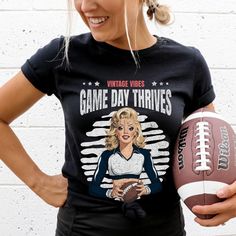 Huddle up for this vintage-inspired pin up football shirt! Featuring a retro pin up cheerleader graphic, it's perfect for football fans and lovers of pin up style. Makes a great gift for any cheerleader fan! Hello there! 😊👋 If you're on the hunt for some seriously cozy T-shirts, you've come to the right place! I'm absolutely passionate about what I do, and my mission is to make your shopping experience absolutely perfect. If you ever have any questions, concerns, or just want to chat about my products, feel free to reach out to me anytime. 👕 Unisex Sizing, Easy Fit! 👕 Unisex sizing(Size chart is in the image) - Shirts are unisex sizing. That means they run slightly larger than women's shirts and slightly smaller than typical men's shirts, almost true to size. Please check the size char Retro Fan Gear Tops For Sports Season, Retro Tops For Sports Season Fan Gear, Retro Game Day T-shirt With Team Name, Vintage Game Day Tops With Team Name, Vintage Game Day Top With Team Name, Retro Team Name T-shirt For Game Day, Cheerleading Fan Apparel Tops For Football Season, Retro Game Day T-shirt For Football Season, Retro Fan Merchandise Tops For Football Season