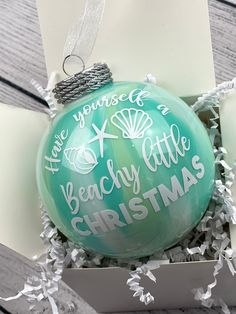 an ornament in a box that says i love you more than a beachy little christmas