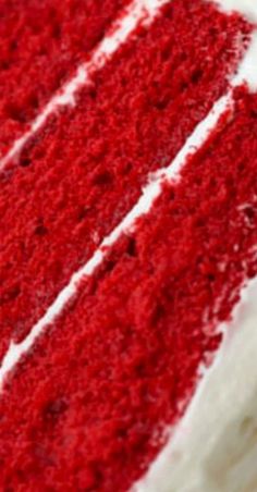 a slice of red velvet cake with white frosting