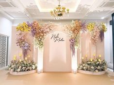 a room with flowers and candles on the wall, decorated in pinks and yellows