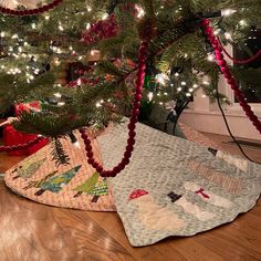 a christmas tree has been decorated with red and green garlands for the holiday season