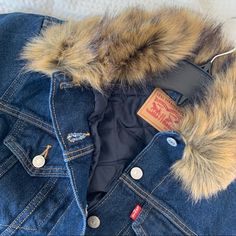 The Upgraded Twist On A Classic. The Deets: Ex-Boyfriend Faux Fur Collar Trucker Denim Jacket | So On-Trend + Versatile For Cold-Weather Layering | Removable Fur Collar On The Classic Levi Medium Wash Denim Jacket + Front Buttons + Two Front Pockets & Side Pockets | Machine Washable | Measurements: 20” Bust + 18” Inseam Sleeve Length + 22.5” Length | Contact For Questions | No Trades/Lowball Offers Pls Sexy | Girly | Vacation Outfit | Wedding Guest Dress | Cocktail Dress | Date Night | Sexy Dres Fall Denim Jacket With Faux Fur Lining, Casual Denim Outerwear With Faux Fur Lining, Levi's Denim Blue Outerwear For Fall, Levi's Dark Wash Outerwear For Fall, Levi's Dark Wash Fall Outerwear, Levi's Trendy Denim Outerwear, Trendy Levi's Denim Outerwear, Levi's Denim Blue Jacket For Winter, Levi's Denim Blue Winter Jacket