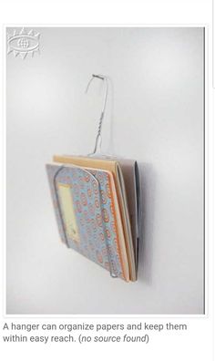 an open book hanging from a hook on a wall