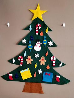 a christmas tree made out of felt with decorations on it