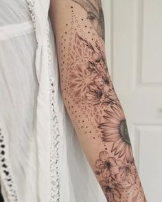 a woman's arm with sunflowers on it