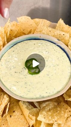 a bowl filled with guacamole surrounded by tortilla chips