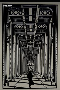 a black and white image of a person walking down a long hallway with lots of columns