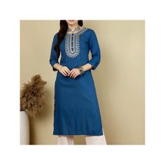 Embroidered Blue Kurti Kurta Top, Long Kurti, Rayon Kurti, Gift for Mum, Gift For Her, Indian Kurti, Festive Kurti, Pakistani, Eid Kurti Please note the length of the dresses as the Model's height is approximately 5 ft 6 inches tall.  Please consider before placing your orders Rayon Soft Material Dry Clean Embroidery Work  Straight Kurti 3/4 Sleeves Round Neck Calf Length- Shoulder Down Approximately 45 Inches Long Side Slits Bottoms & Accessories NOT included Size XS (32 Bust) UK 6-8 Size S (34 Traditional Blue Kurta With Handwork, Festive Kurti, Kurti Long, Blue Kurti, Kurta Top, Rayon Kurti, Indian Kurti, Straight Kurti, Long Kurti